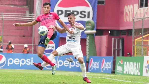 El "Flaco" Martínez protege la esférica ante la pegajosa marca de Wilson Godoy. (