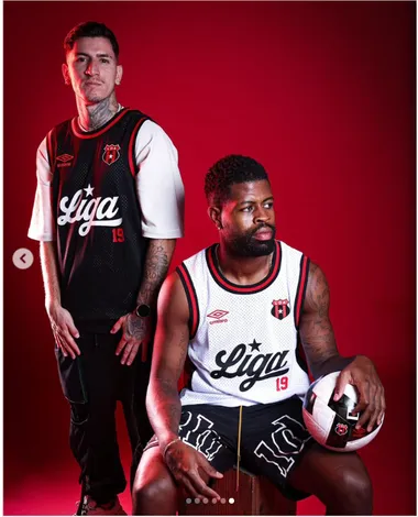 Anderson Canhoto y Manjrekar James posando con la nueva camiseta de baloncesto. (