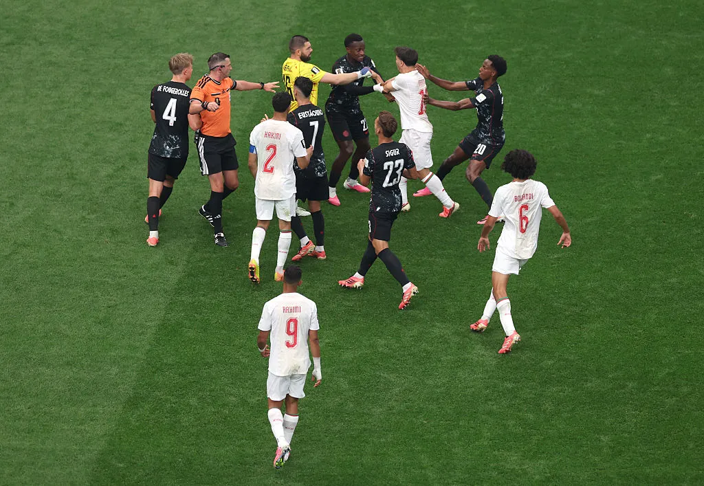 HOUSTON, TEXAS - JULY 04: Players scuffle following an argument between Achraf Hakimi #2 of Morocco and Richie Laryea #22 of Canada during the FIFA World Cup 2026 Round of 16 match between Canada and Morocco at Houston Stadium on July 04, 2026 in Houston, Texas. (Photo by Lars Baron/Getty Images)
