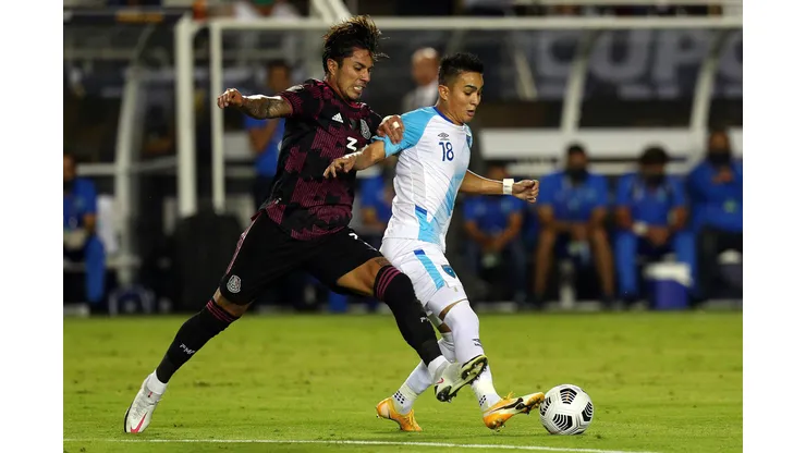 DALLAS, TEXAS - JULY 14: Carlos Salcedo #3 of Mexico and Robin Betancourth #18 of Guatemala fight for the ball in the first half at Cotton Bowl on July 14, 2021 in Dallas, Texas. (Photo by Richard Rodriguez/Getty Images)