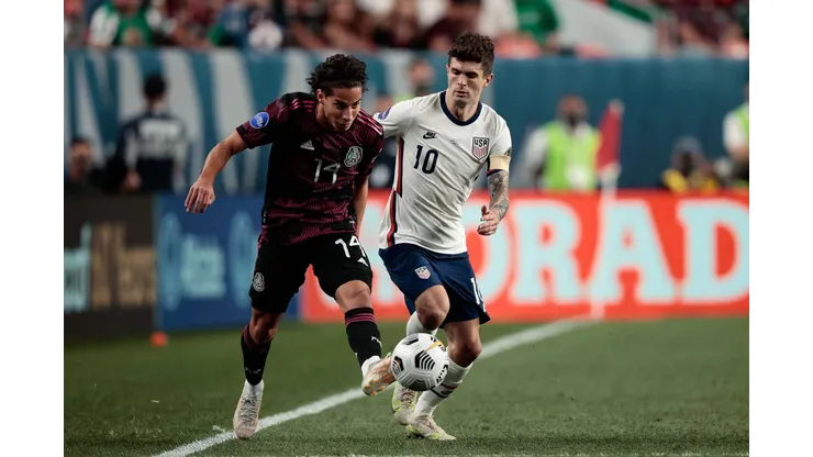 Jun 6, 2021; Denver, Colorado, USA; Mexico midfielder Diego Lainez (14) and United States forward Christian Pulisic (10) battle for the ball in extra time during the 2021 CONCACAF Nations League Finals soccer series final match at Empower Field at Mile High. Mandatory Credit: Isaiah J. Downing-USA TODAY Sports