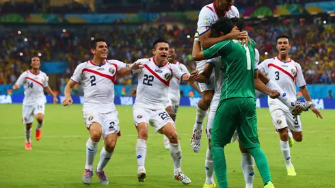 RECIFE, BRAZIL - JUNE 29: Keylor Navas of Costa Rica is swarmed by teammates in celebration after defeating Greece in a penalty shootout during the 2014 FIFA World Cup Brazil Round of 16 match between Costa Rica and Greece at Arena Pernambuco on June 29, 2014 in Recife, Brazil. (Photo by Paul Gilham/Getty Images)