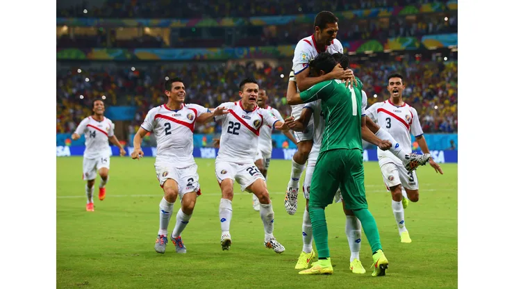 RECIFE, BRAZIL - JUNE 29: Keylor Navas of Costa Rica is swarmed by teammates in celebration after defeating Greece in a penalty shootout during the 2014 FIFA World Cup Brazil Round of 16 match between Costa Rica and Greece at Arena Pernambuco on June 29, 2014 in Recife, Brazil. (Photo by Paul Gilham/Getty Images)