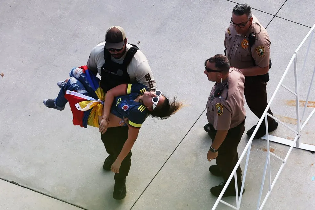 MIAMI GARDENS, FLORIDA – JULY 14: A police officer carries an 	unconscious fan the CONMEBOL Copa America 2024 Final match between Argentina and Colombia at Hard Rock Stadium on July 14, 2024 in Miami Gardens, Florida. (Photo by Megan Briggs/Getty Images)