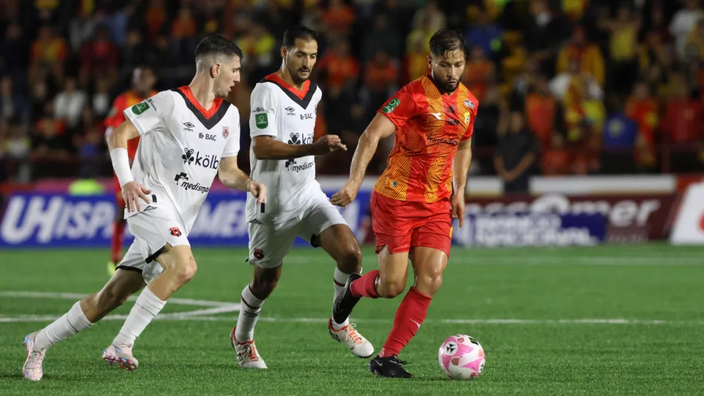 Elías Aguilar cuida la esférica del asedio liguista, encabezado por Celso Borges y Alberto Toril. (Foto: Mayela López / La Nación)