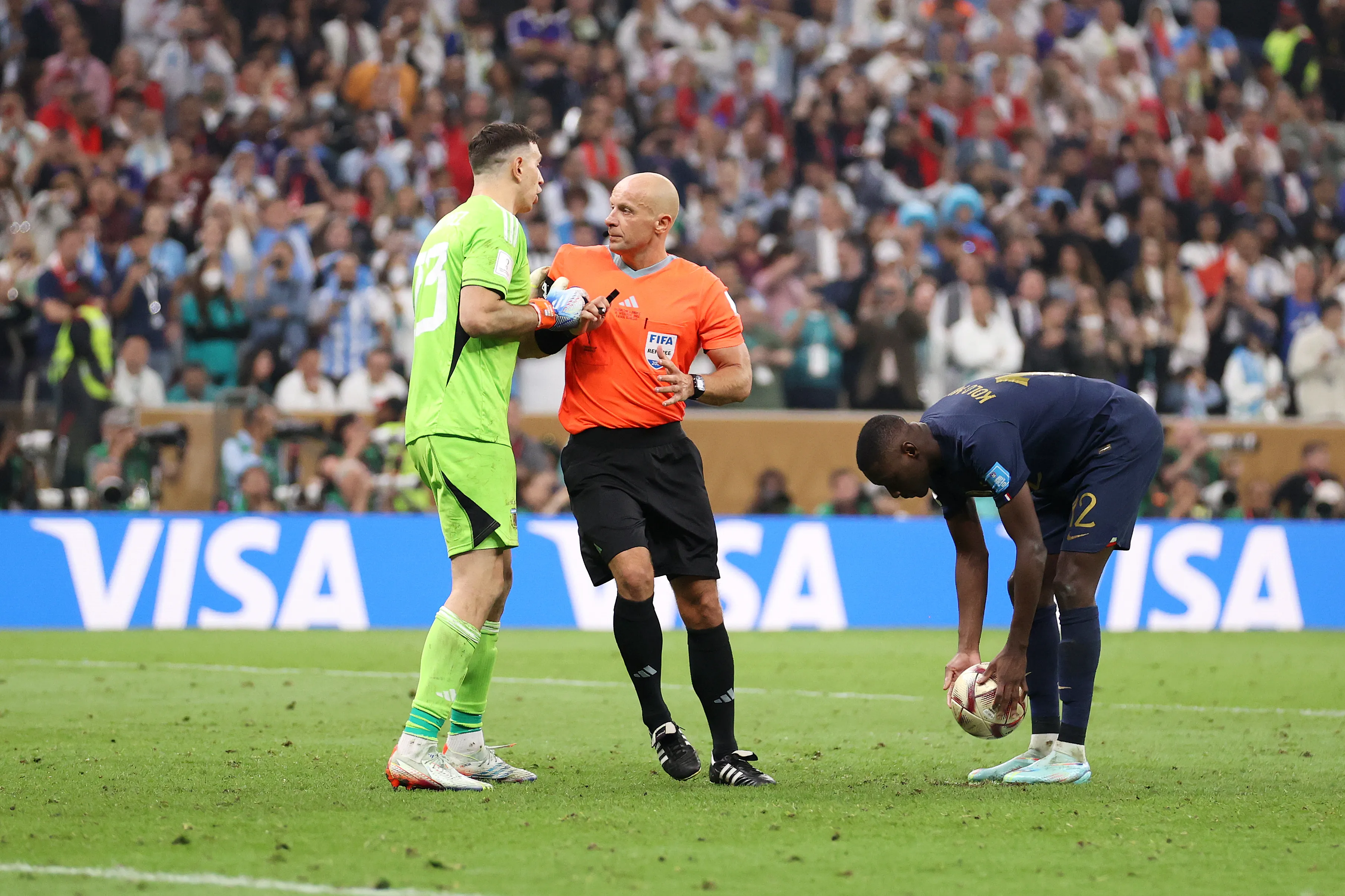 LUSAIL CITY, QATAR – DECEMBER 18: Emiliano Martinez of Argentina is prevented by referee Szymon Marciniak from speaking to Randal Kolo Muani of France in the penalty shootout during the FIFA World Cup Qatar 2022 Final match between Argentina and France at Lusail Stadium on December 18, 2022 in Lusail City, Qatar. (Photo by Julian Finney/Getty Images)